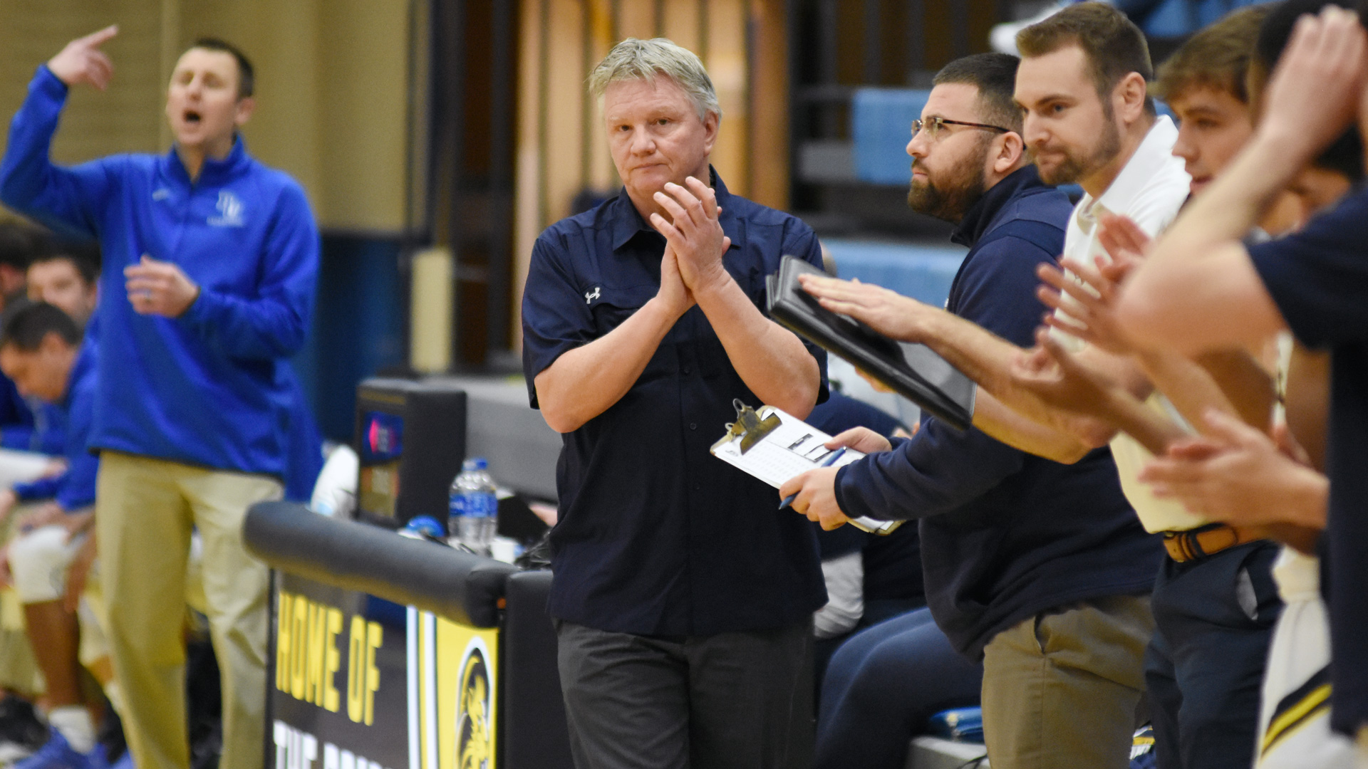 Clarke head coach Jim Blaine clapping in approval of a Pride play against Bethel.