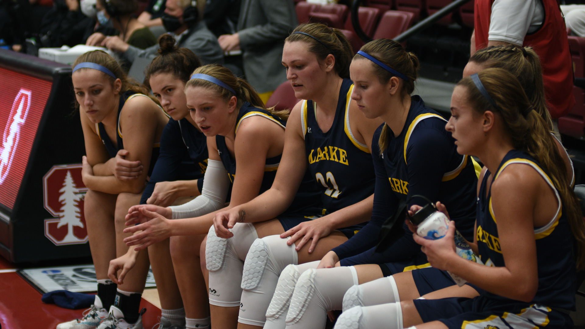 Clarke women's basketball players on the bench during a timeout