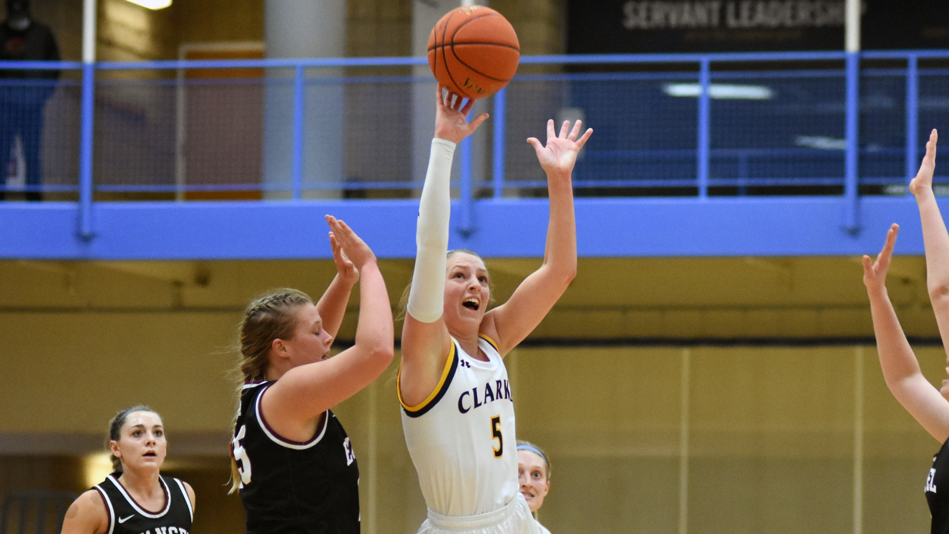 Nicole McDermott putting up a floating shot with defenders surrounding