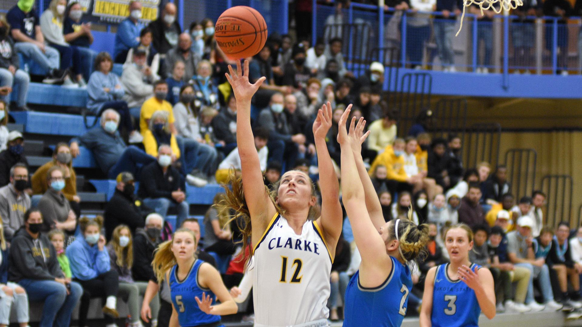 Clarke's Taylor Haase attempting a layup against a challenging defender