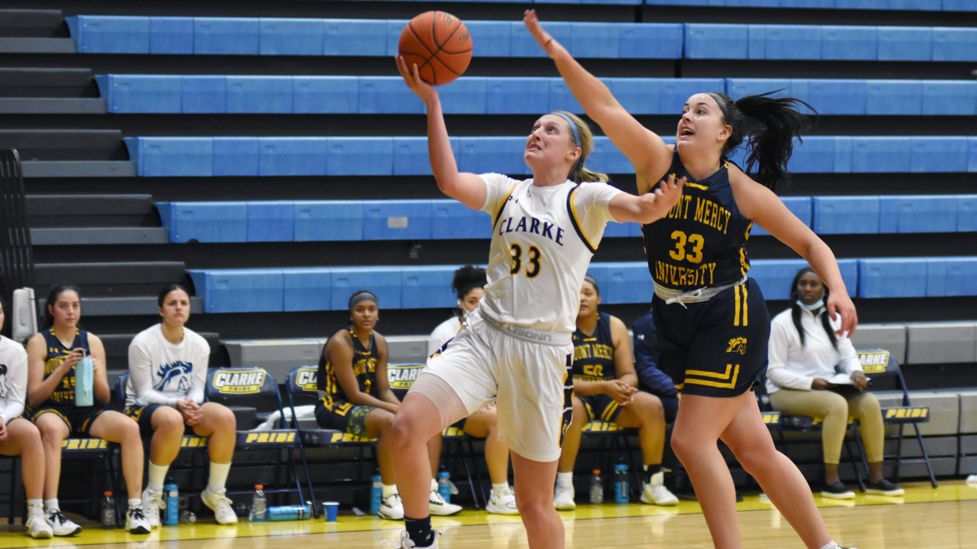 Clarke's Tina Ubl goes up for a layup with a defender on her back