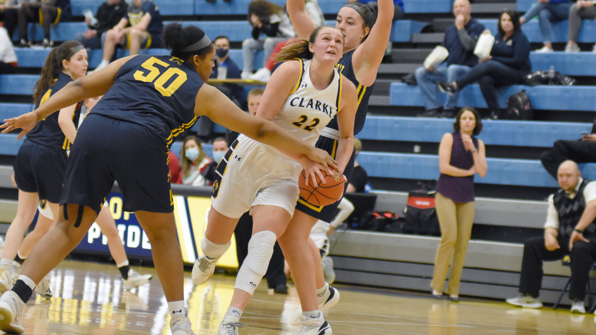 Clarke's Emma Kelchen making a move to the basket against defenders