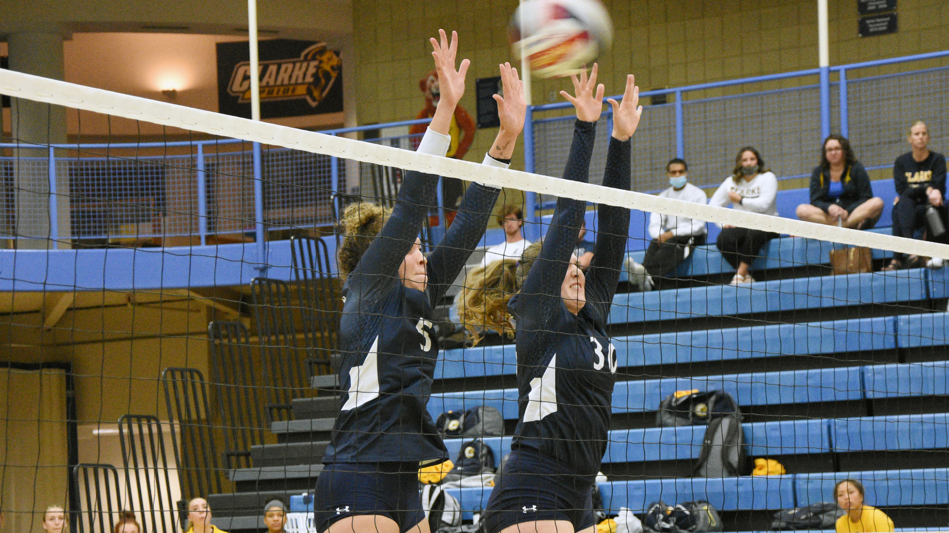 Lily Himmelmann and Jaida Kroning attempt a block at the net