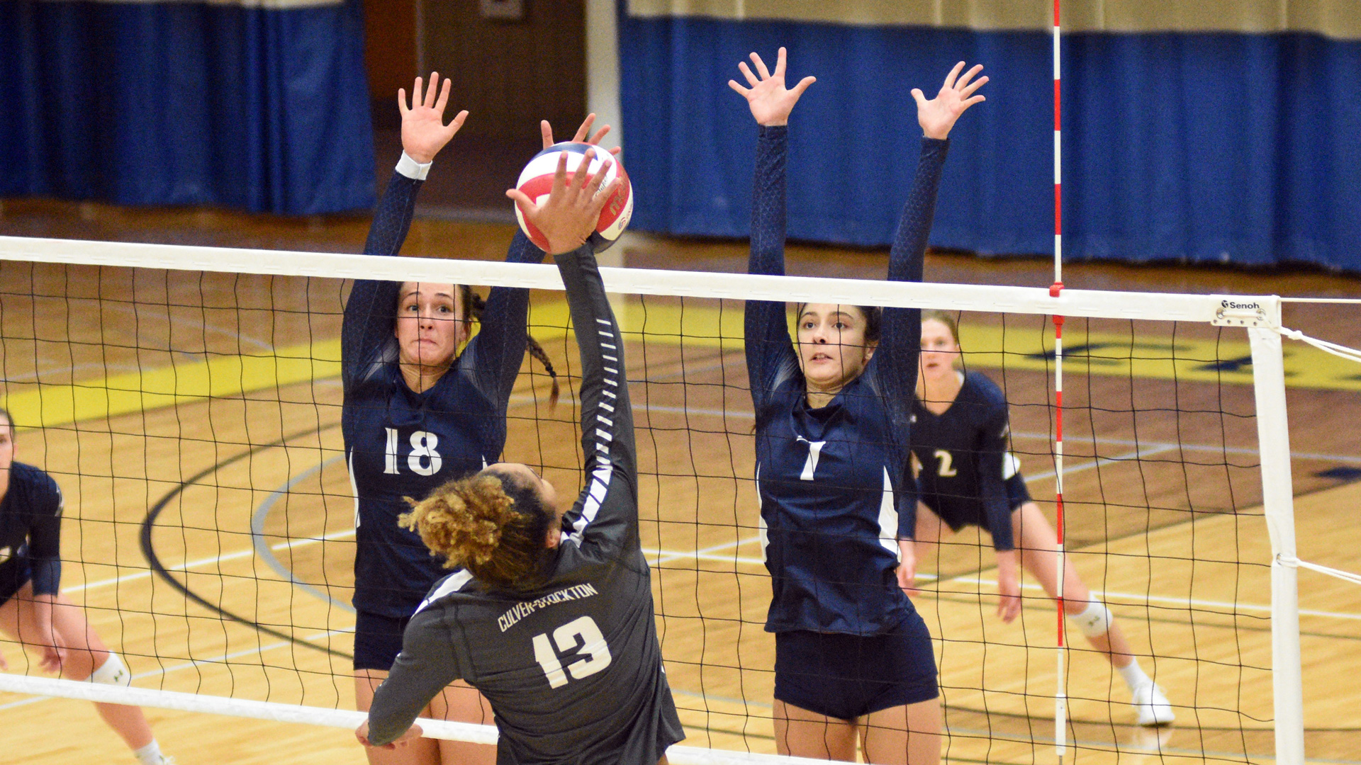 Rebecca Schroeder and Gianna Garza jumping to attempt a block